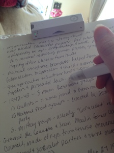Me taking notes with my smart pen. The pen transmits the to receiver clamped to the top of the page.